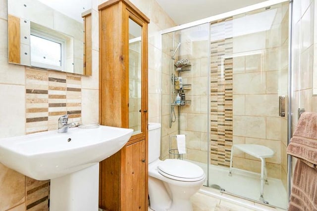 Both the main bathroom and the en suite to the first bedroom have been recently upgraded. This en suite has a touch of class thanks to its walk-in shower and tiled walls and floor. There is also a wash hand basin and low-flush WC.