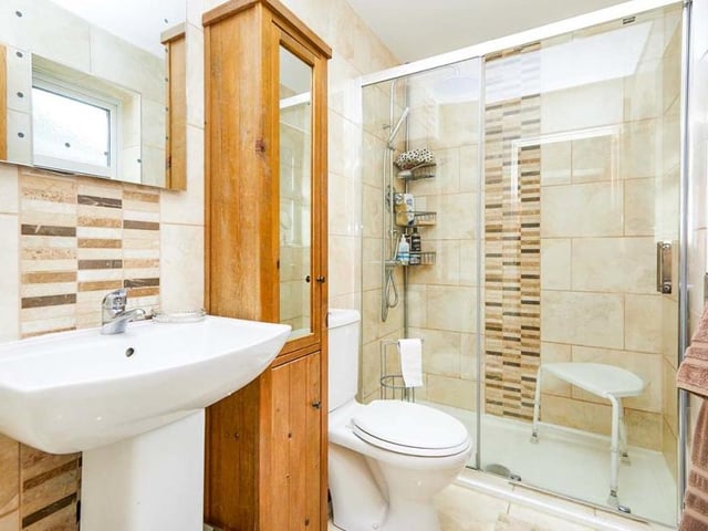 Both the main bathroom and the en suite to the first bedroom have been recently upgraded. This en suite has a touch of class thanks to its walk-in shower and tiled walls and floor. There is also a wash hand basin and low-flush WC.