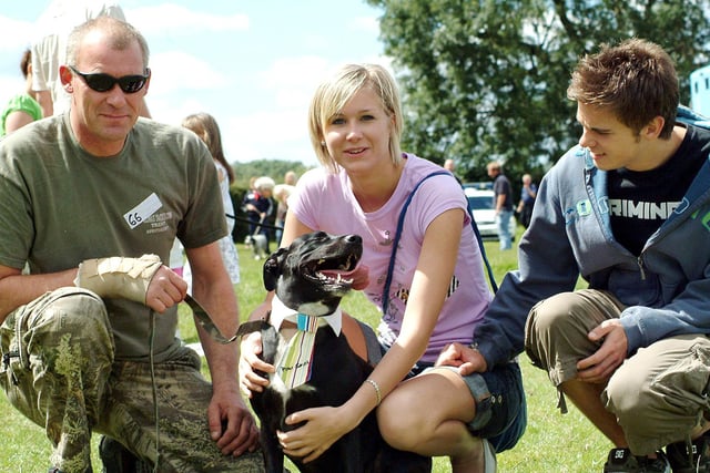 Rocky the Staffordshire labrador cross shows off his collar and tie during the dog show at the Mansfield Woodhouse vets clininc with owners from left, Paul Pepperday, Katy Pepperday and Jonathan Scott. (2007)