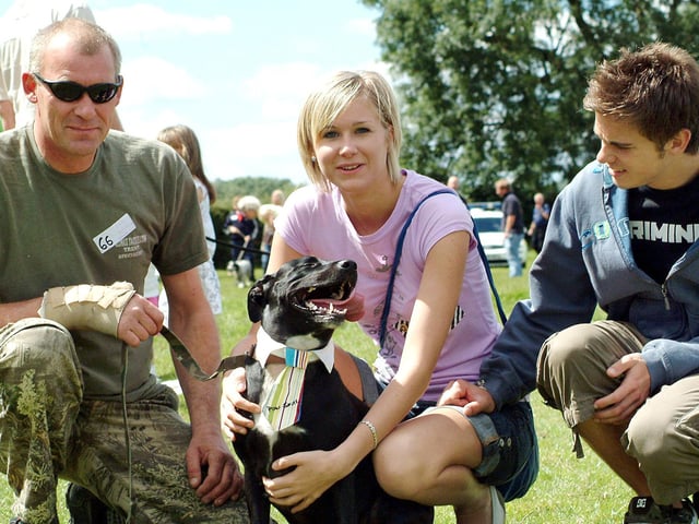 Rocky the Staffordshire labrador cross shows off his collar and tie during the dog show at the Mansfield Woodhouse vets clininc with owners from left, Paul Pepperday, Katy Pepperday and Jonathan Scott. (2007)