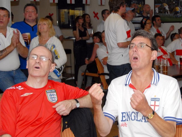 Mansfield Town staff and fans watch  England's first match against USA.