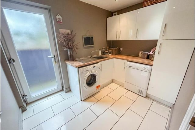 Off the kitchen is this handy utility room, with more storage units, plus space for a washing machine and tumble dryer.