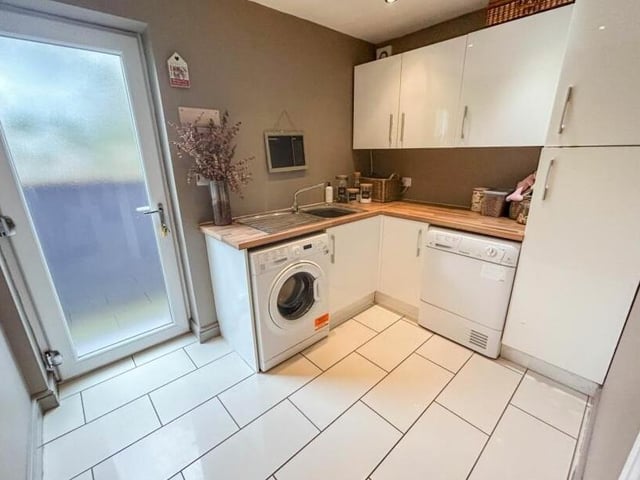 Off the kitchen is this handy utility room, with more storage units, plus space for a washing machine and tumble dryer.