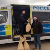 Farmer Alex Marhsall hands over the bags of potatoes to the Nottinghamshire Police Neighbourhood Support Unit