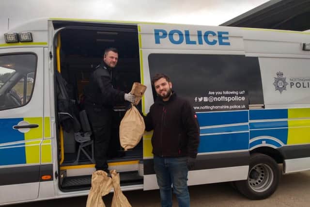 Farmer Alex Marhsall hands over the bags of potatoes to the Nottinghamshire Police Neighbourhood Support Unit