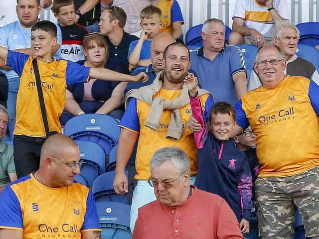 Mansfield Town fans watch the Carabao Cup first round match against Derby County.