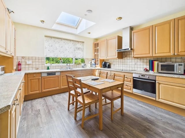 The dining kitchen is equipped with integrated appliances and has an adjoining utility room