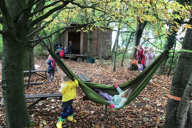 Pupils playing outdoors as part of a Forest School session.