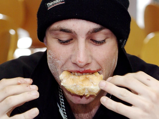 Canning gets in a mess in a doughnut eating competition held at West Notts college to raise money for children in need.