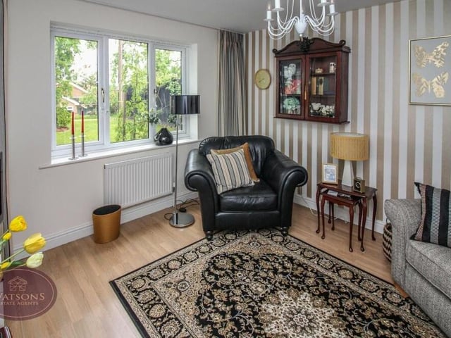 One of the four bedrooms at the Kimberley house can be found on the ground floor. But it is currently being used as a sitting room, with a window overlooking the front of the property and wood-effect laminate flooring