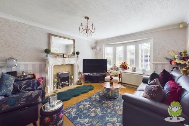 Let's open our photo gallery of the £270,000 Forest Town gem in the spacious living room, which is adorned with a feature fireplace and a large bay window, creating a cosy yet bright ambience.