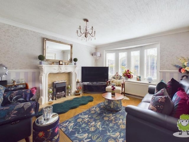 Let's open our photo gallery of the £270,000 Forest Town gem in the spacious living room, which is adorned with a feature fireplace and a large bay window, creating a cosy yet bright ambience.