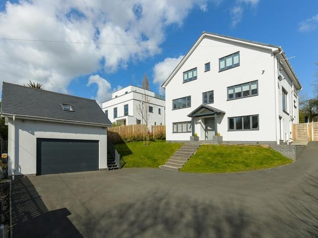 Our final photo of the house gives you the frontage from another angle. The house sits majestically, with the double garage to the left.