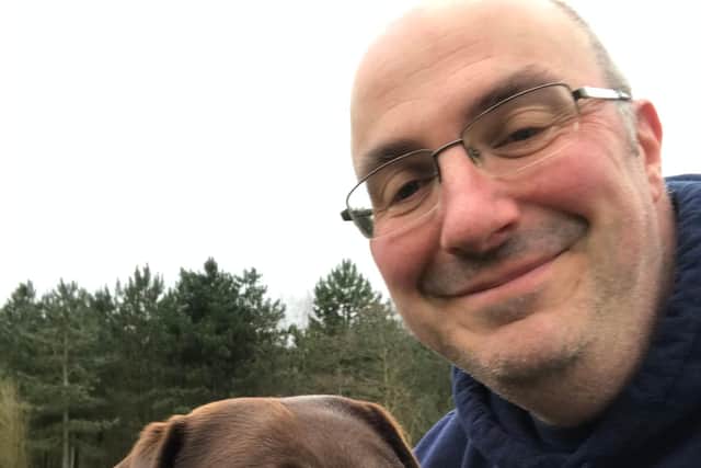 Dave Stott and his pet chocolate labrador Luna who he still enjoys taking for a walk despite having suffered heart failure