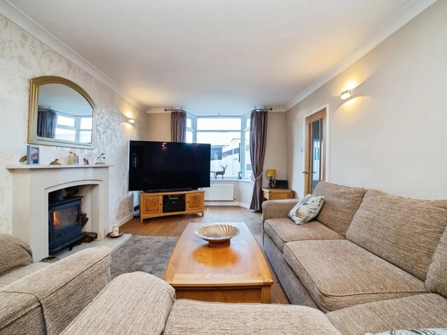 The elegant lounge boasts a multi-fuel burner with a marble surround providing a warm, inviting atmosphere.