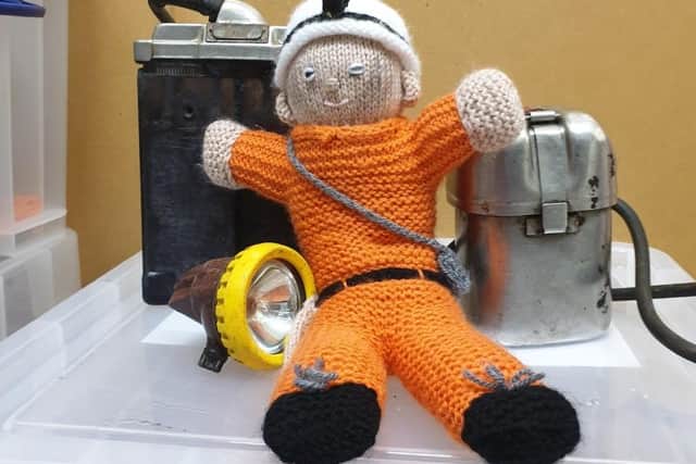 Fred the knitted miner was donated by a volunteer.