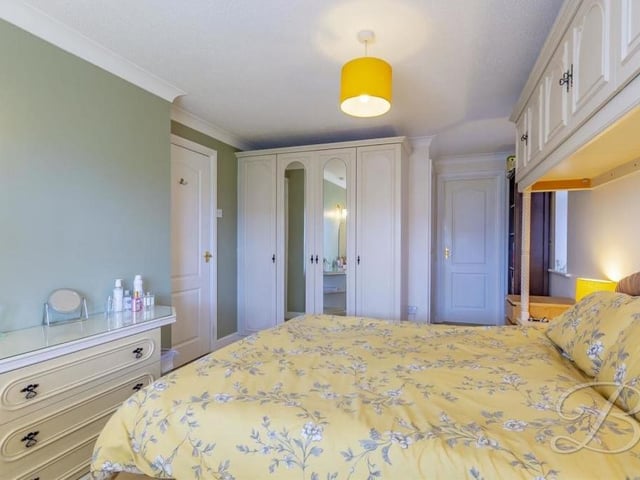 A different shot of the main bedroom, which has a touch of elegance about it, as well as access to an en suite bathroom.