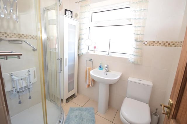 Here is the first of two shower rooms at the Ravenshead dormer bungalow. It's on the ground floor and features a shower cubicle, low-flush WC and wash basin, with tiled floor and walls.