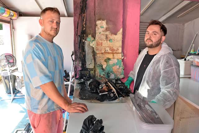 Frenchie Frenchie owners Arran and Liam Giles inspect the fire damage.