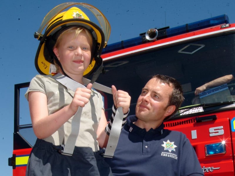 Toni Bedford aged 10 of Mansfield is transformed into a Fire Fighter by Crew Manager Richard Scott at the Ladybrook Carnival on Saturday.