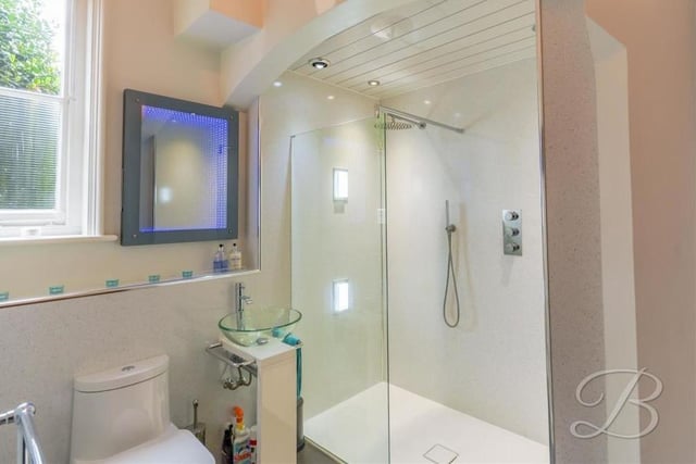 The spacious ground floor at the Mansfield property also features this shower room. It comes complete with a walk-in shower cubicle, low-flush WC, glass hand wash basin, chrome, heated towel-rail, infinity mirror, storage cupboard and fitted shelves.