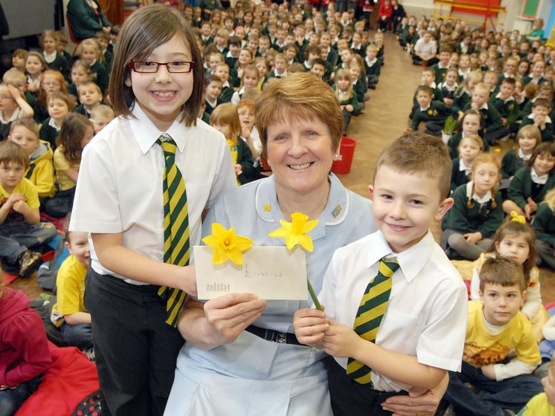 Molly and Harry Thomas, both pupils at High Oakham Primary School, present the money collected so far from their daffodil growing challenge totalling £1,085.62 to Marie Curie nurse Carolyn Clarke.  The presentation was made in 2011 in a special assembly for the young growers who all brought in examples of their work.