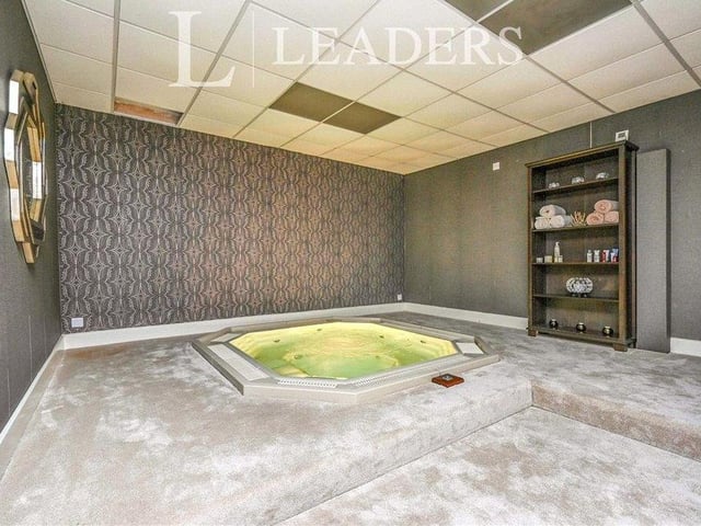 One of the main assets of the £1.95 million property is its leisure area, which pulls together a heated swimming pool, sauna, six changing rooms and this sunken jacuzzi. The pool has three sets of French doors that overlook the woodland gardens