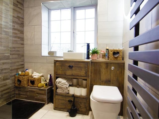 Also on the first floor is this attractive shower room. A modern three-piece suite comprises a double walk-in, wet room-style shower, vanity wash basin and low-level WC. It is fully tiled and also has a stylish, heated towel-rail.