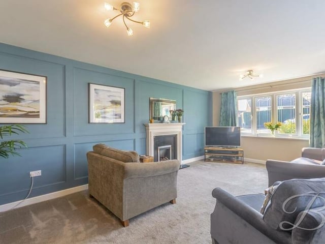We begin our tour of the Rooley Drive bungalow in the superb living room, which offers space as well as comfort. Decorative panelling adds to its appeal.
