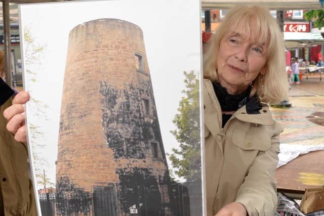 Angela Morris, of Sutton Heritage Society, with a photograph of Lindley's Mill.
