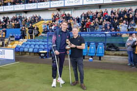 The crutches tell the story as sports editor John Lomas gives Elliot Hewitt his Chad Reader's Mansfield Town Player of the Year award on Saturday. Photo by Chris & Jeanette  Holloway/The Bigger Picture.media