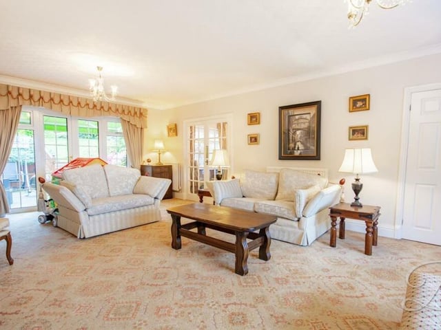 A third and final view of the elegant lounge or living room. The French doors lead outside to the garden.