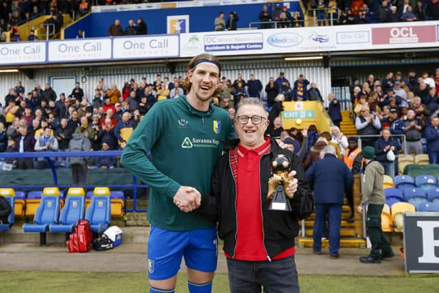Aden Flint receives his trophy from Chad sports editor John Lomas.
