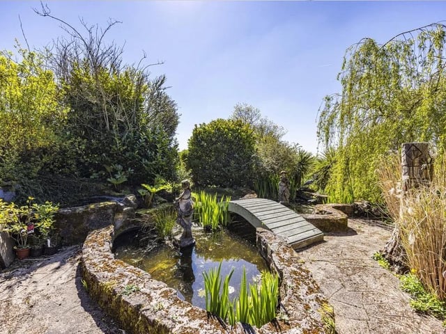 The tranquil garden boasts a stunning pond