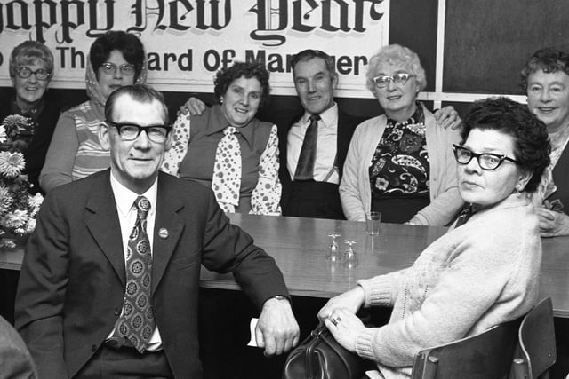 George O'Cain, leader of Hendon Advice Centre Over 60 Club, with some of the members after their Christmas treat dinner in 1974.