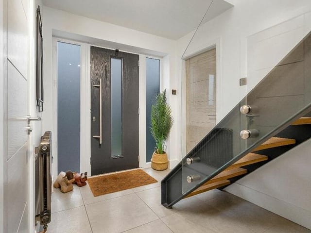 Stepping inside the £585,000 property, you are immediately struck by its stylish nature. The entrance hall features unique, exposed steels, hidden behind one of which is mood lighting, and also a contemporary floating staircase, with inset oak steps and a frameless glass balustrade.