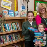 Sherwood Junior School headteacher Helen Simpson and two pupils with their new books.