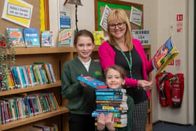 Sherwood Junior School headteacher Helen Simpson and two pupils with their new books.