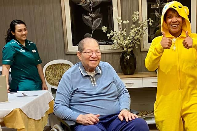 Staff and residents being entertained by Pudsey Bear