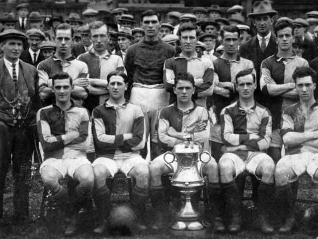 Mansfield Town won the Notts FA Senior Cup in season 1922-23 with a 2-1 victory over Newark Athletic at Sutton Town's ground.  They are pictured here with the trophy.
