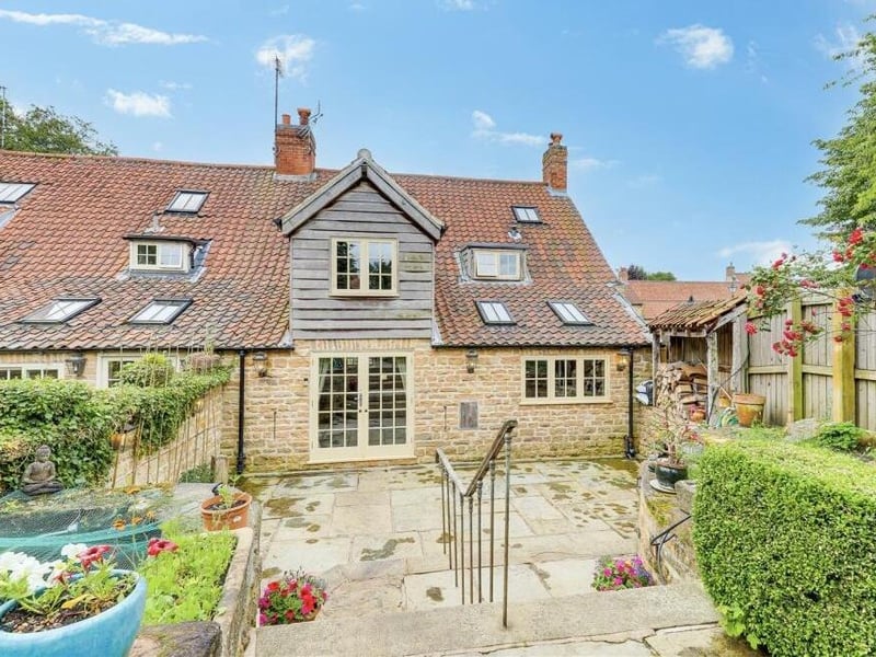 And so to the outside of the Linby cottage. This is a view from the private, enclosed rear garden, which features a fish pond (to the left)