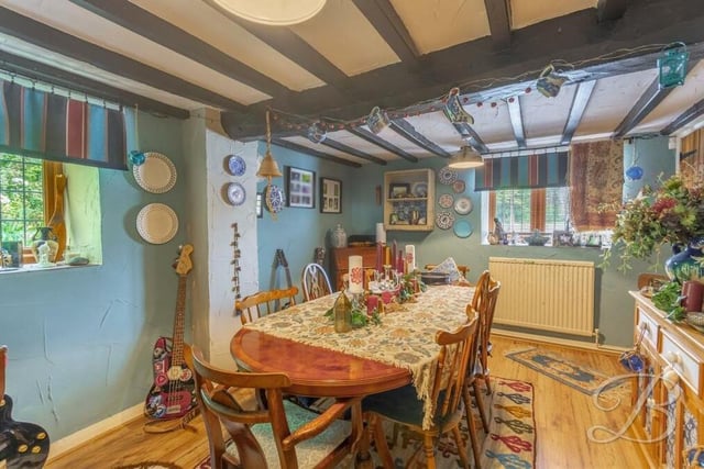 This reception room is currently being used as an exquisite dining room but could also be turned into a home office or games room. It has exposed ceiling beams and a cupboard for additional storage.