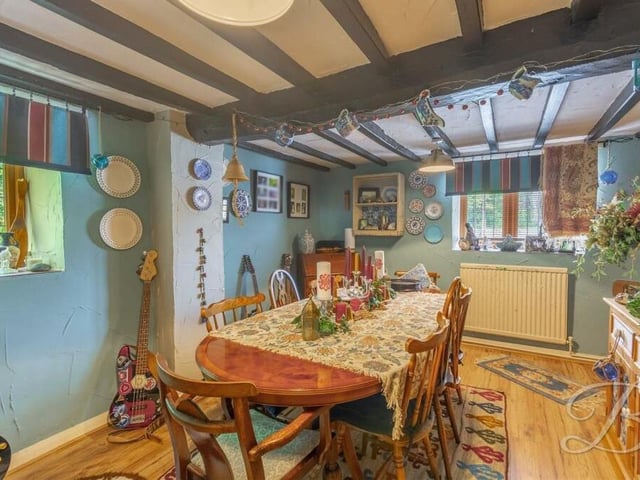 This reception room is currently being used as an exquisite dining room but could also be turned into a home office or games room. It has exposed ceiling beams and a cupboard for additional storage.