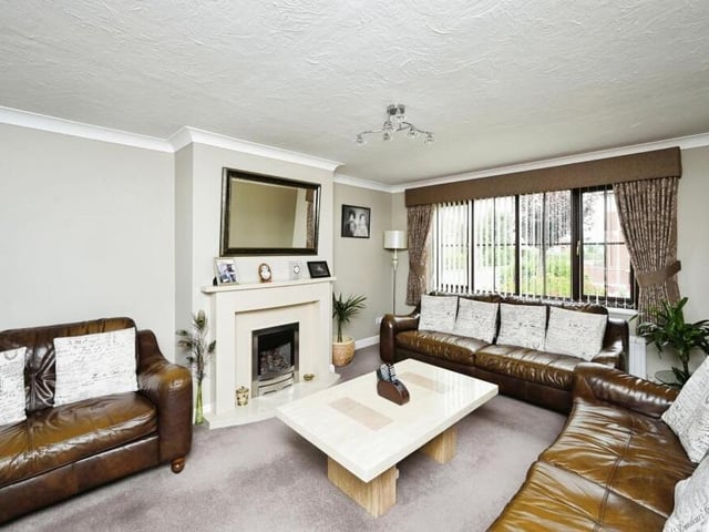 The living room is tastefully decorated and has, at its heart, a charming feature fireplace.