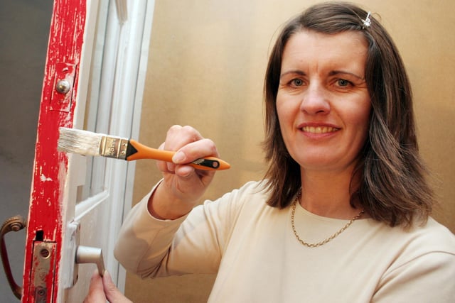 2006: Volunteer Sarah Robinson applies the finishing touches ahead of the opening of Eastwood Hope Project Charity Shop.