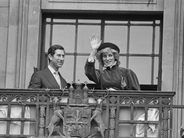 Diana, Princess of Wales (1961-1997), wearing a Caroline Charles outfit with a hat by John Boyd, and Charles, then Prince of Wales waving from the balcony of Nottingham Council House during a visit to Nottingham, England, 7th March 1985. (Photo by Steve Wood/Daily Express/Hulton Archive/Getty Images)