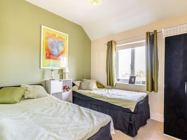 This bedroom has space for twin beds if required. It faces the back of the Sutton property.