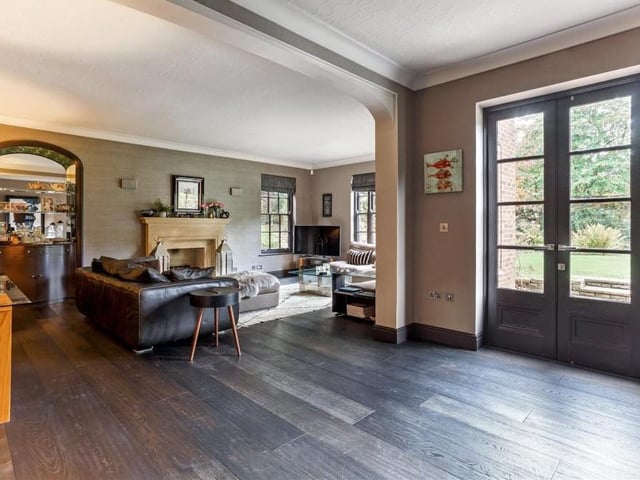 A second shot of the large sitting room at the £1.25 million Berry Hill property, this time showing the open gas fireplace with stone surround.