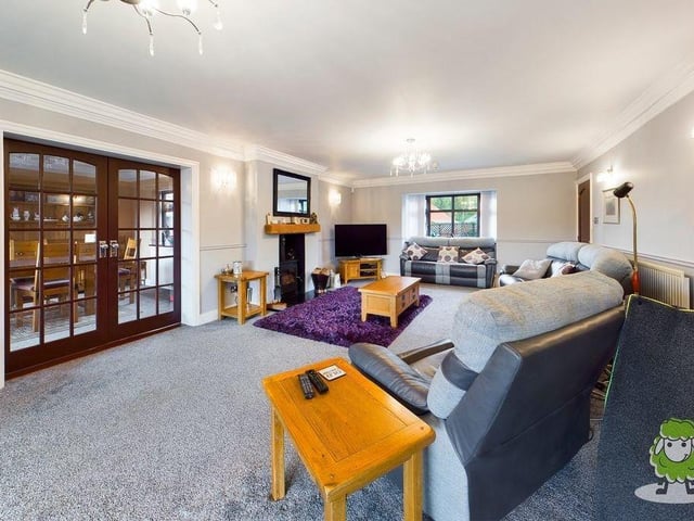 The living room from a different angle, underlining its size and style. Attractive French doors lead to the dining room.