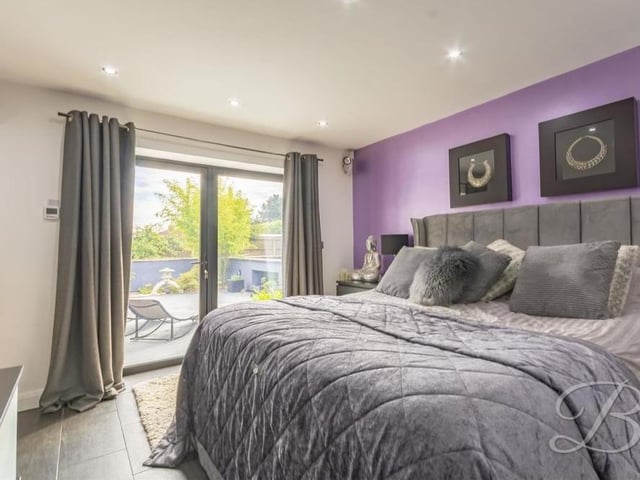 This second shot of the master bedroom shows a set of French doors that lead directly outside to the private garden.